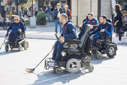 Photo of group of men in wheelchairs playing a sport
