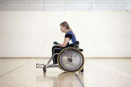 Photo of woman in wheelchair playing sports