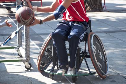 Photo of person in wheelchair playing basketball