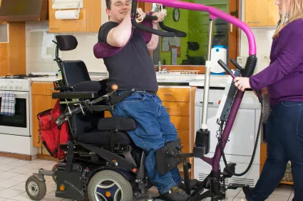 Photo of man lifting out of a power wheelchair
