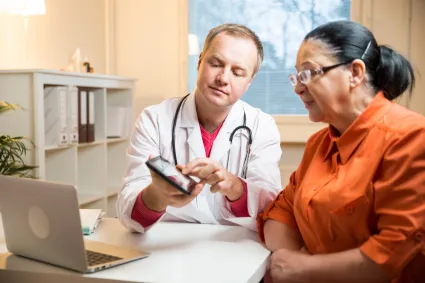 Photo of clinician talking to woman with TBI