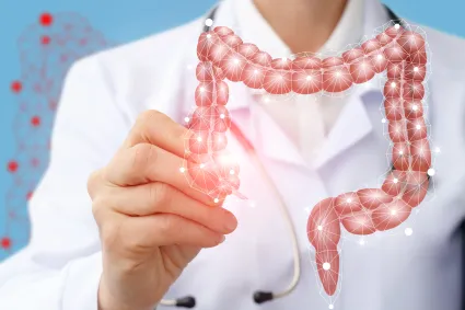 Photo of clinical staff with illustration of bowel