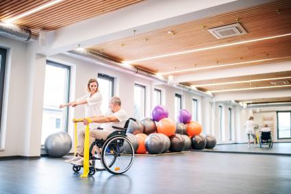 Photo of man in wheelchair doing physical therapy
