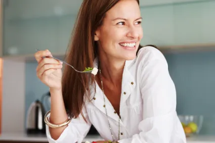 a white woman Eating salad