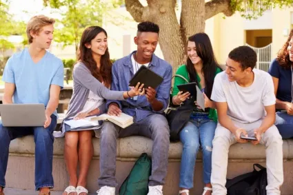 peers outside on school bench 