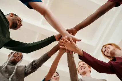 interdisciplinary team with hands in 