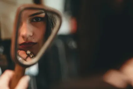 teen looking in mirror