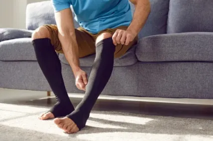 person putting on compression socks