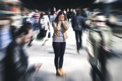 Photo of woman in crowd, overwhelmed