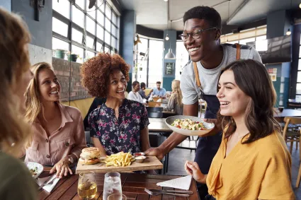 Happy young friends hangout in restaurant 