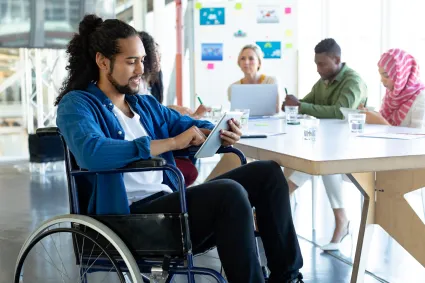 Photo of man in wheelchair in office