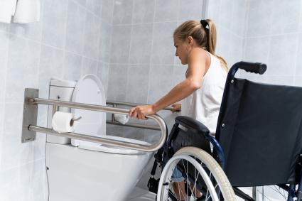 Woman in wheelchair in bathroom