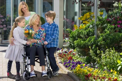 Photo of family with woman in wheelchair