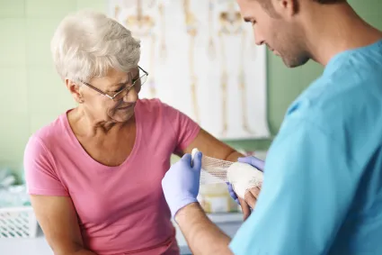 Photo of clinician dressing a burn wound