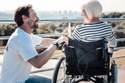 Photo of woman in wheelchair and personal care attendant