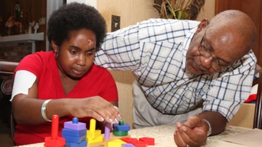 Father teaching child with blocks