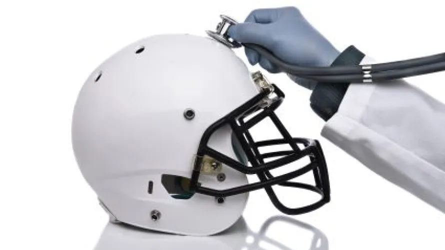 Stethoscope held to a football helmet