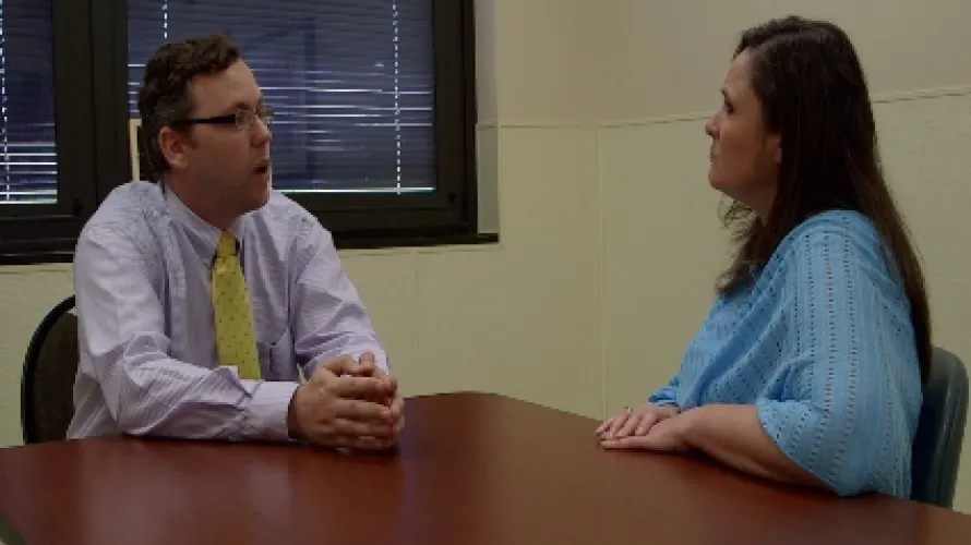 Clinician and patient talking across a table