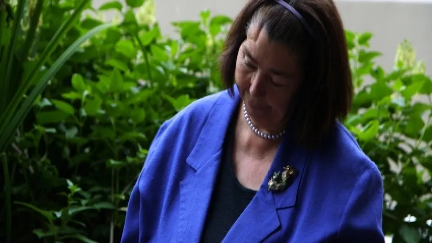 Woman in blue blazer looking away