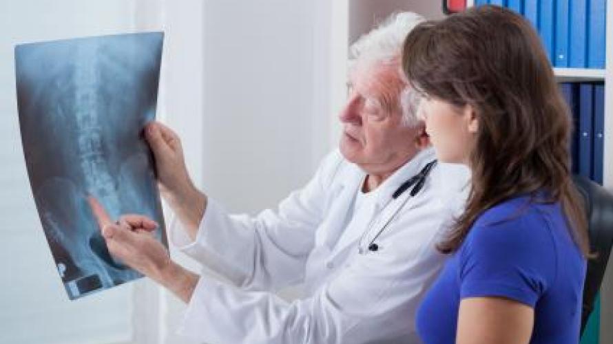 doctor showing x-ray to patient