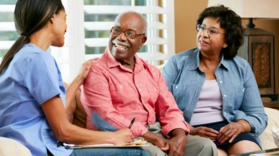 Group of three people sitting together on a couch