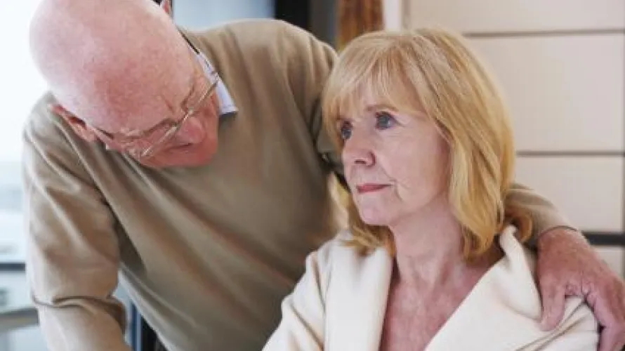 Older man with arm around woman