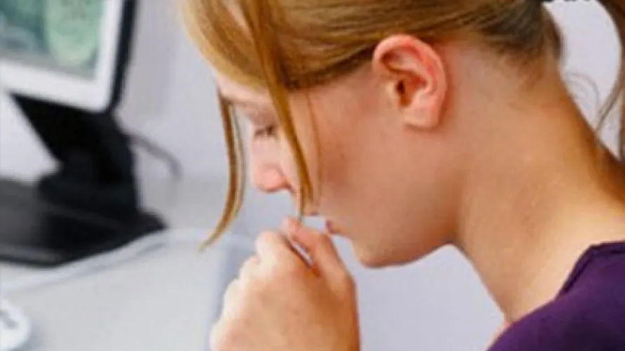 Person coughing into closed fist