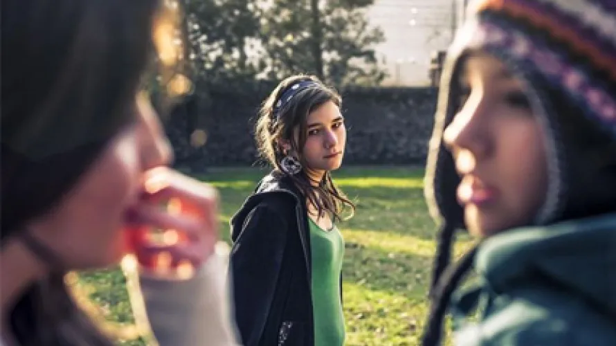 Person looking at two people having a conversation