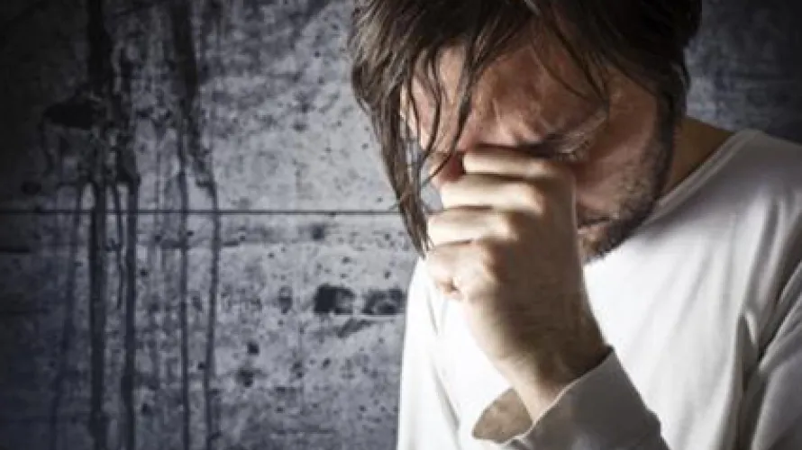 Man holding his head in hand