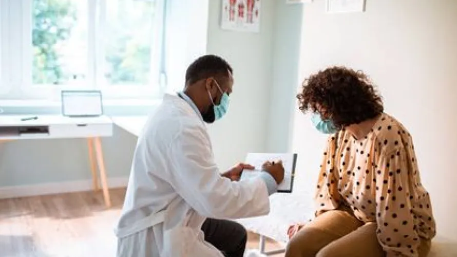Doctor reviewing chart with mask on