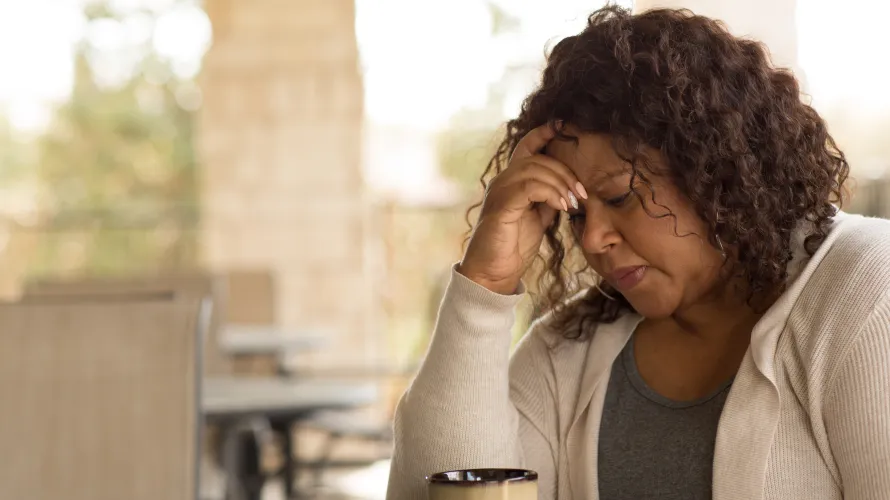 A woman holding her head in her hands