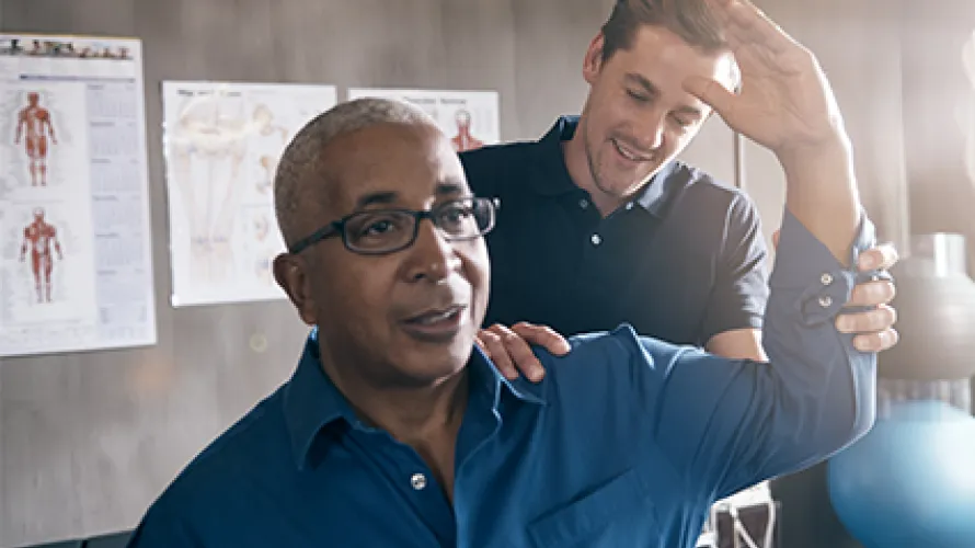 Physical therapist working with a man