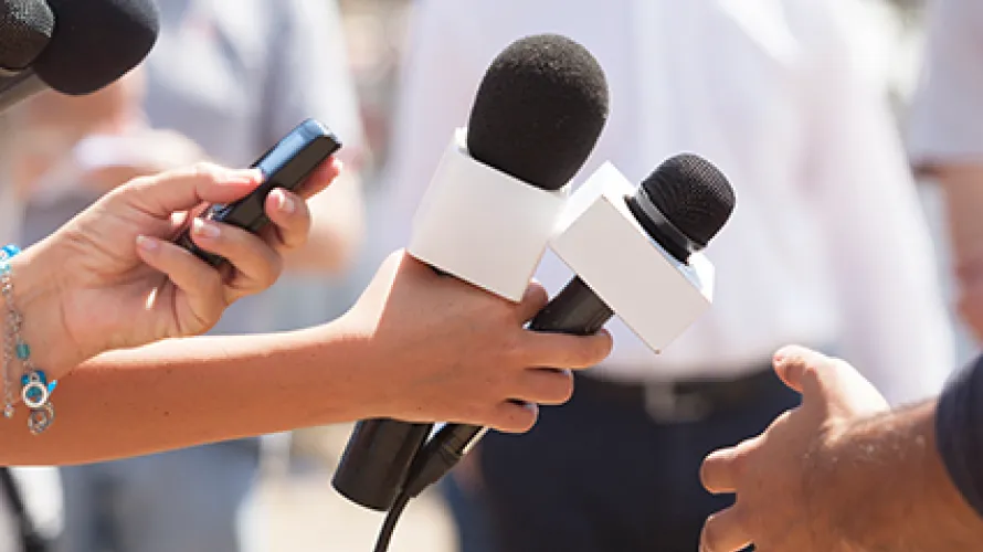 Microphones pointing at person in interview