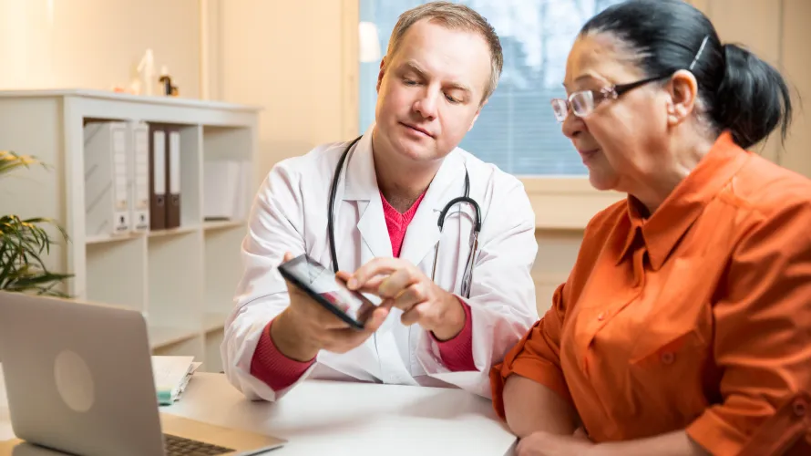 Photo of clinician talking to woman with TBI