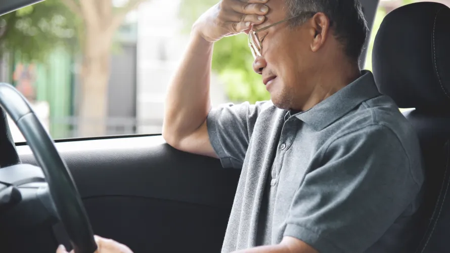Man holding his hand to his head