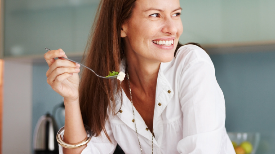 a white woman Eating salad