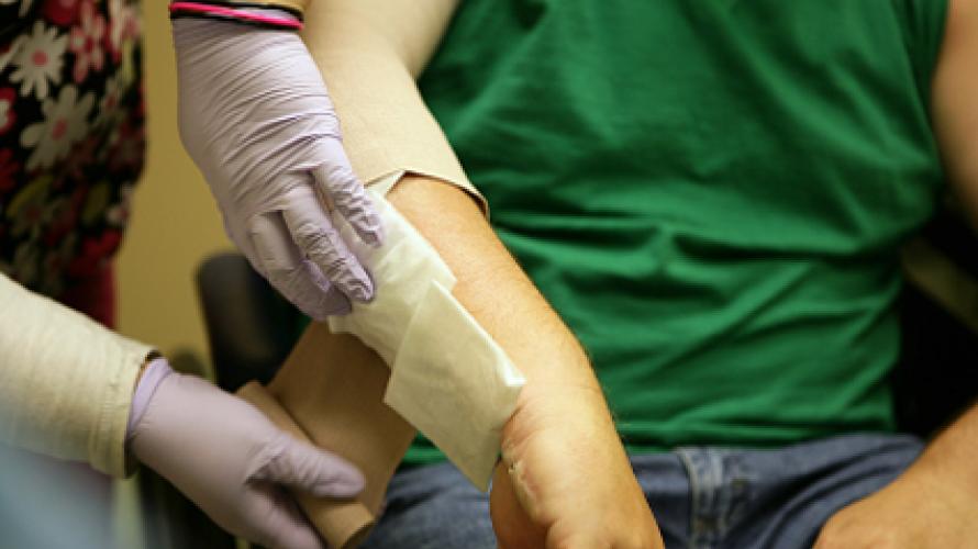 Applying bandage to wound