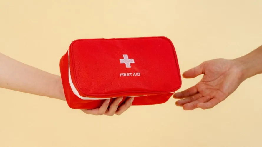 person handing someone a first aid kit 