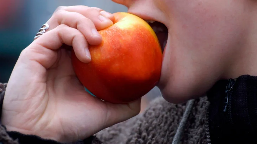 person biting apple 